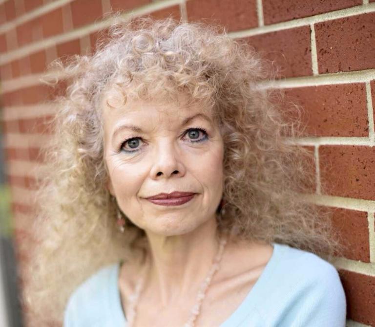 a woman with curly blonde hair