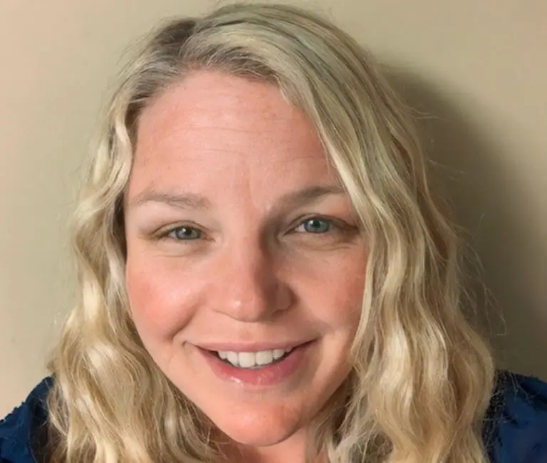 a woman with blonde hair smiling
